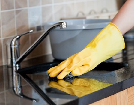 Professional domestic cleaner working in an EN5 home kitchen
